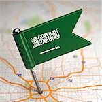 Small Flag of Saudi Arabia on a Map Background with Selective Focus.