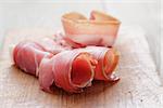 dried jamon slices on wood table, spanish traditional food