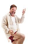 Middle-aged man rocks out playing air guitar in his underwear.  Isolated on white.