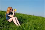 Young girl with binoculars in a meadow searching the sky