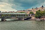 Train passing on famous Pont de Bir-Hakeim bridge across Seine River in Paris, France (toned).