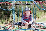 cheerful positive boy spending fun time at the playground