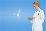 Blonde doctor using tablet pc against medical background with blue ecg line