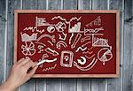 Composite image of hand writing brainstorm with chalk on chalkboard on grey wooden planks