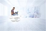 Man wearing glasses sitting on cloud using laptop and looking at camera against city scene in a room