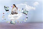 Businesswoman sitting cross legged with hands together against clouds in a room