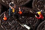 Miniature Construction Workers in Conceptual Imagery With Cookies