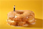 Miniature Police Officers in Conceptual Food Imagery With Doughnuts