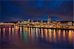 Portland Oregon Downtown City Skyline Along Willamette River Waterfront at Evening Blue Hour with Storm Clouds Panorama