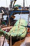 Fishing vessel. Great catch of fish in thrall. The process of casting the fish in the tank. Large freezer trawlers.