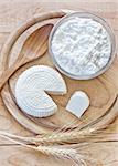 Tzfat cheese and cottage cheese with wheat grains. Symbols of judaic holiday Shavuot. Selective focus.