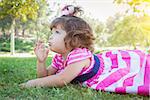 Cute Baby Girl Enjoying Her Lollipop Outdoors.