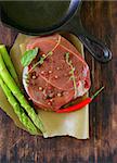 piece of raw meat beef steak with spices and herbs