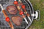 Cooking on the barbecue grill assortment sausages steak and skewers