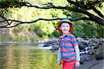 handsome smiling boy standing by the river