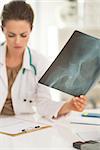 Closeup on medical doctor woman with fluorography working in office