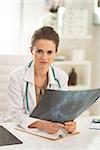 Medical doctor woman with fluorography in office