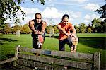 Couple stretching legs on park bench