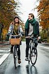 Young couple cycling on street