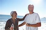 Portrait of happy couple by seaside