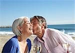 Man pecking woman on cheek