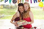 Teenage girl and friend with birthday gift