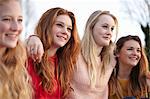 Four teenage girlfriends posing for portrait