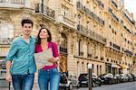 Young couple with map, Paris, France