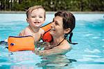 Mother and child swimming in pool
