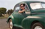 Portrait of young man in vintage morris minor
