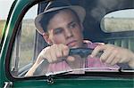 Young man looking through windscreen of vintage morris minor