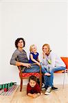 Studio portrait of couple sitting with son and daughter