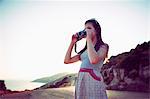 Girl taking photographs at dusk, Kas, Turkey