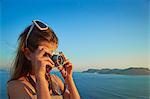 Girl taking photographs on holiday, Kas, Turkey