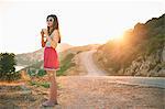 Girl holding camera at sunset, Kas, Turkey