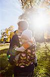 Father carrying baby daughter in carrier