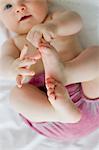 Baby girl playing with feet