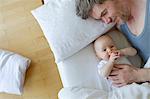 Father and baby daughter on bed