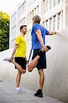 Two men stretching hamstrings