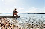 Man on jetty, Lake Starnberg, Bavaria, Germany