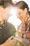 Man holding woman's hand, woman wearing engagement ring