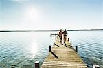 Couple on jetty, Lake Starnberg, Bavaria, Germany