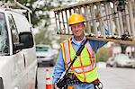 Cable lineman carrying ladder from service truck