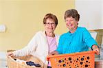 Senior women in a laundry room with baskets