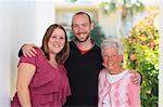 Portrait of a senior woman standing with her son and daughter-in-law