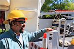 Power engineer with lift bucket truck to work on power lines, Braintree, Massachusetts, USA