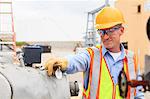 Electrical engineer examining pressure sensor at an electric power plant