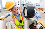 Engineer examining transducer gauge at electric power plant