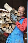 Smiling man carrying firewood, Ronneby, Blekinge, Sweden