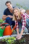 Happy young couple working in garden, Stockholm, Sweden